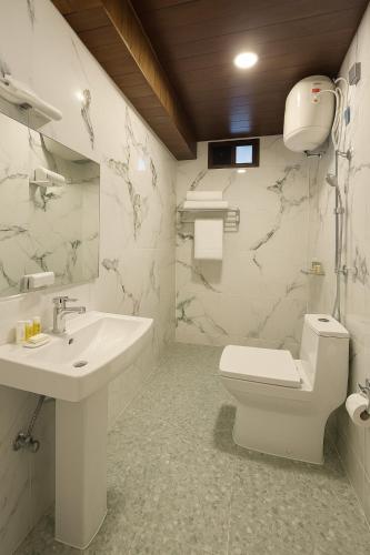 a bathroom with a toilet and a sink at Mystique Valley by Trekocity in Lachung