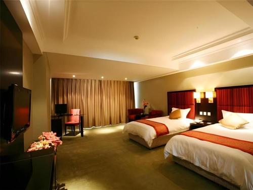 Ένα ή περισσότερα κρεβάτια σε δωμάτιο στο Longda Ruiji Business Hotel Harbin