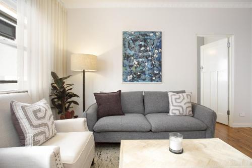 a living room with a couch and a table at Coastal Living Just Metres From Coogee Beach in Sydney