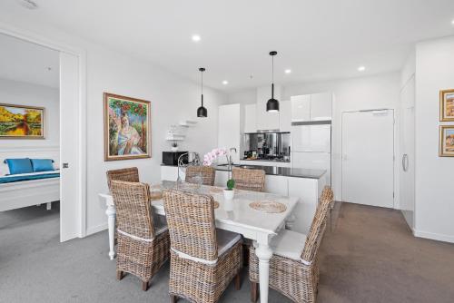 a kitchen and dining room with a table and chairs at A taste of paradise in inner city suburbia in Melbourne