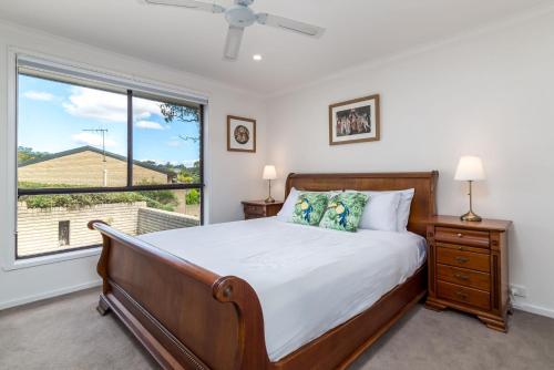 a bedroom with a bed and a large window at Spacious and Restful Holiday Home with Backyard in Weetangerra
