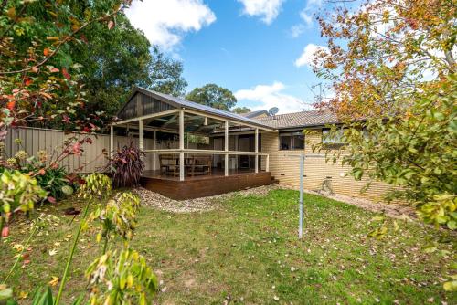 an image of a house with a porch at Spacious and Restful Holiday Home with Backyard in Weetangerra