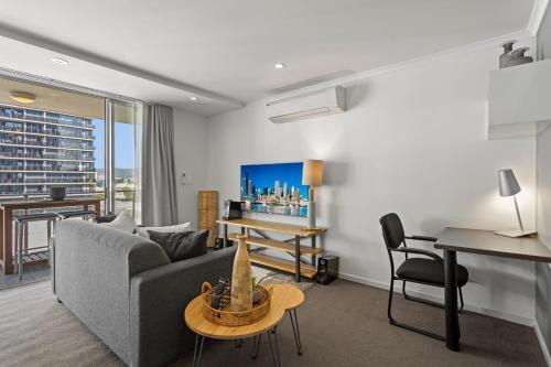 a living room with a couch and a table at Chic 2-Bed Apartment & 5 minutes walk to QPAC in Brisbane