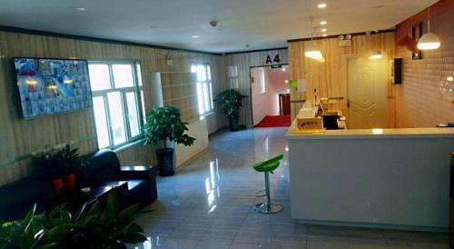 a lobby of an office with a counter and plants at PAI Hotels·Urumqi South Gate Xinhua Bookstore in Ürümqi