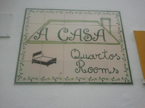 a sign on a wall that reads aas a records at A Casa in Portel