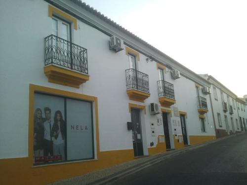 a row of buildings on a city street at A Casa in Portel