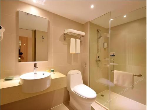 a bathroom with a toilet and a sink and a shower at City Comfort Inn Zhanjiang Xuwen Port Wharf Chengdong in Xuwen