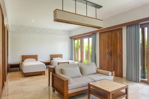 a living room with a couch and two beds at Medewi Surf Villa Luxury in Airsatang