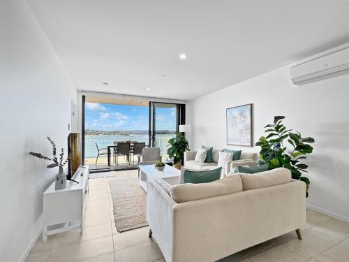 a living room with two couches and a table at Deluxe 3-Bed Unit with Views in Batemans Bay