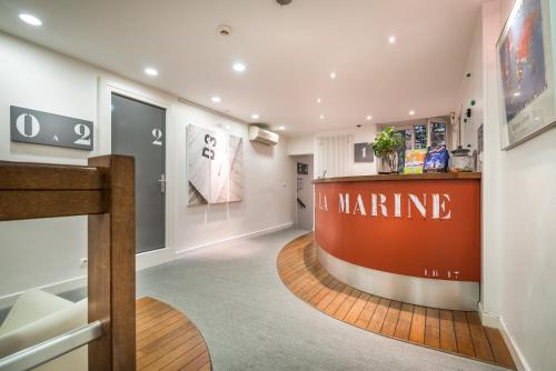 a store lobby with a martinez sign on the wall at Hotel La Marine, Vieux Port in La Rochelle