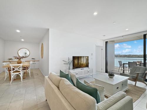 a living room with a couch and a table at Deluxe 3-Bed Unit with Views in Batemans Bay