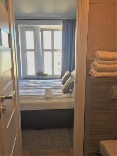 a bedroom with a window and a bed in a room at Apartmenty Mariacka 20 -Self Check-In 24h -Głośniej w weekendy - Noisy on the weekend in Katowice