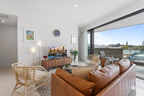 a living room with a couch and a large window at Gorgeous 3-Bed Apartment with City Views in Brisbane