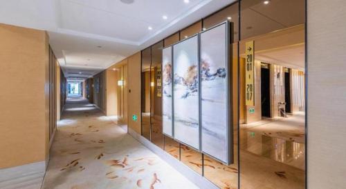 a hallway with glass walls in a building at Xincheng hotel in Zunyi