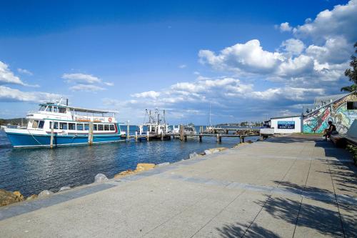 a couple of boats docked at a dock at Chic 2-bed Bridgeview Apartments Batemans Bay in Batemans Bay