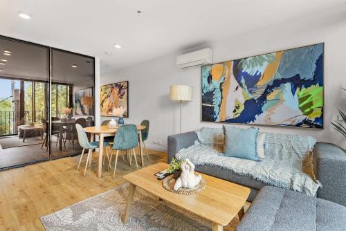 a living room with a couch and a table at Contemporary 1-Bed in the Heart of St Kilda in Melbourne