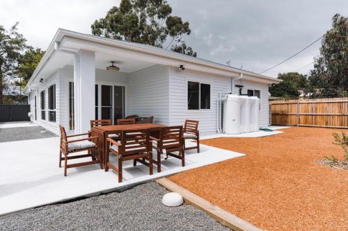 a house with a table and chairs in a yard at Exquisitely Spacious 3-Bed Home in Fyshwick