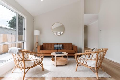 a living room with a couch and two chairs at Exquisitely Spacious 3-Bed Home in Fyshwick