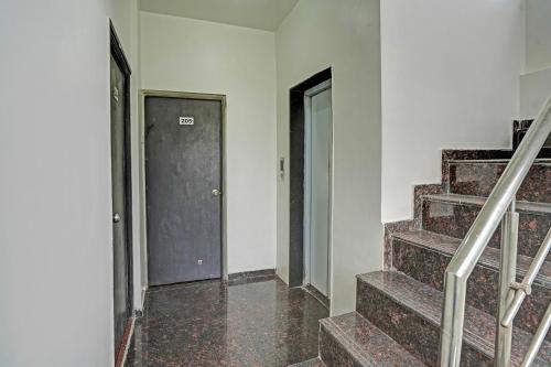 an empty hallway with stairs and a door at Via Shahi Villa in Pune