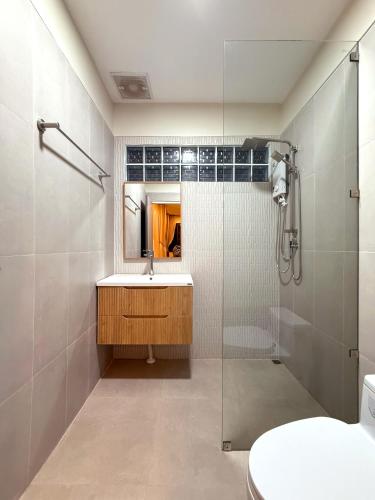 a bathroom with a sink and a shower at Sabaii Bay Resort in Ban Tai