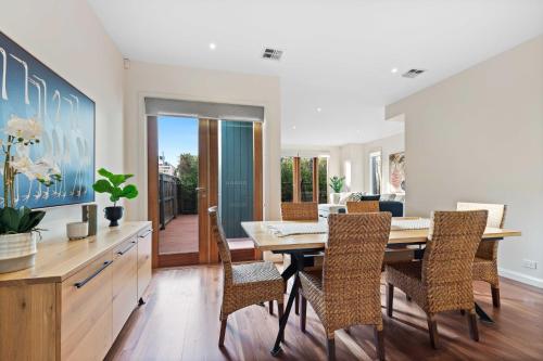 a dining room with a table and chairs at Chic 2-Bed Home By Bustling Shops in Yarraville