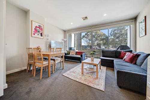 a living room with a couch and a table at Tranquil Apartment in Green, Well Connected Suburb in Lyons