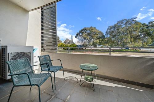 three chairs and a table on a balcony at Tranquil Apartment in Green, Well Connected Suburb in Lyons