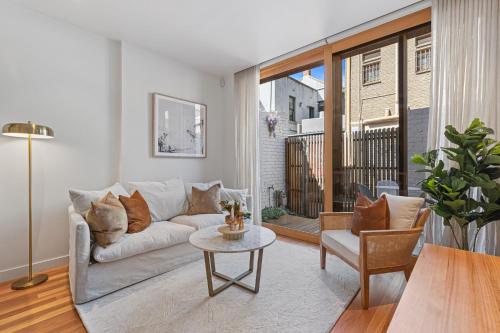 a living room with a couch and a table at Stylish 2-bed Victorian Terrace in Carlton in Melbourne