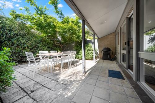 a patio with a table and chairs and a grill at Gorgeous 2-Bed Townhouse with Patio, BBQ & Parking in Kingston
