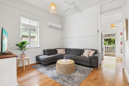 a living room with a couch and a table at Tranquil 3-Bed Family Home with Spacious Backyard in Brisbane