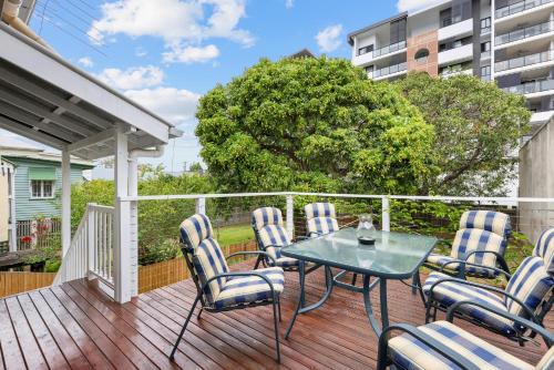 a patio with chairs and a table on a deck at Tranquil 3-Bed Family Home with Spacious Backyard in Brisbane