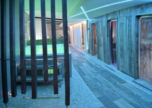 a view of a room with a bed and glass walls at Vea Resort Hotel in Mercato San Severino