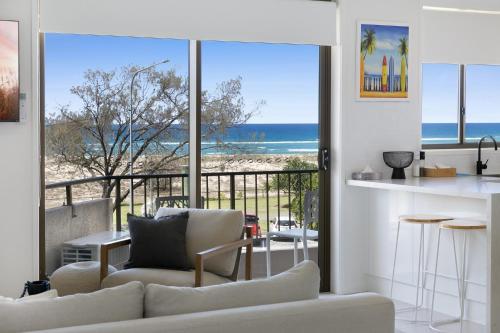 a living room with a view of the beach at Beachfront Studio with Balcony & Stunning Views in Gold Coast