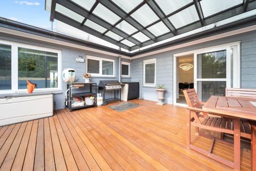 a screened in porch with a table and chairs on a deck at 4-Bed Family Home with Spacious Backyard and BBQ in Lyons