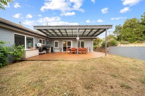 a pergola over a patio of a house at 4-Bed Family Home with Spacious Backyard and BBQ in Lyons