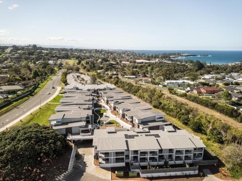an aerial view of a city with buildings and the ocean at First Floor 3-Bed Stunning Unit by The Ocean in Kiama