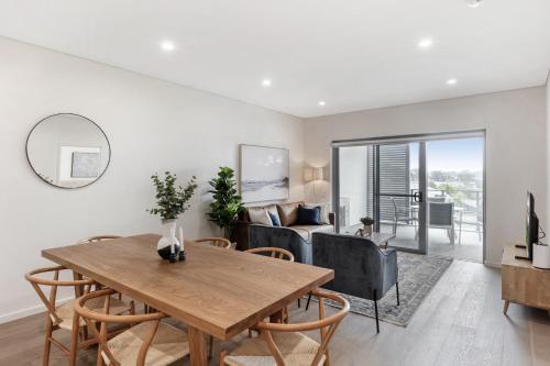 a living room with a table and chairs and a couch at 3-Bed Apartment in Beautiful Kiama with Study Nook in Kiama