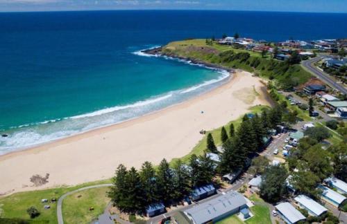an aerial view of a beach and the ocean at 3-Bed Apartment in Beautiful Kiama with Study Nook in Kiama