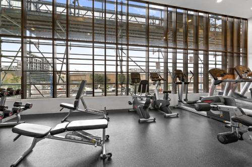 a gym with a bunch of exercise equipment in a building at Chic 1-Bed with Pool by River Ferry & Amenities in Sydney