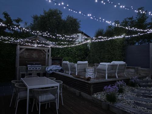 a patio with chairs and a table and lights at Lovely 3-Bed with Alfresco Dining in Prime Suburb in Ballarat