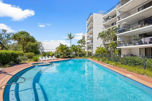 a swimming pool in front of a apartment building at Salt & Sol at Marcoola Beach Resort in Marcoola