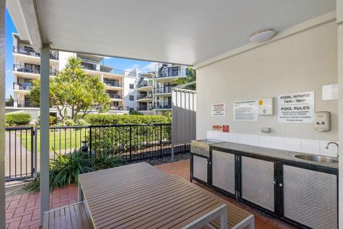 a balcony with a table and a sink in a building at Salt & Sol at Marcoola Beach Resort in Marcoola