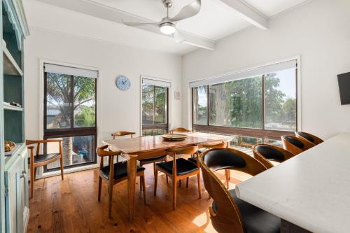 a dining room with a wooden table and chairs at Spacious 4-Bed Home 5-min from the Beach in Capel Sound