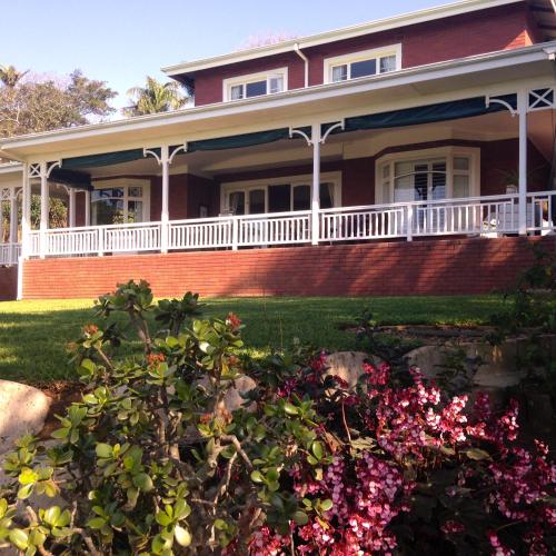 a large house with flowers in the yard at Southey House in Kloof