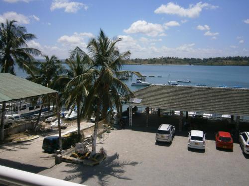 a view of a marina with cars parked in a parking lot at Tudor Water Sports Hotel in Mombasa