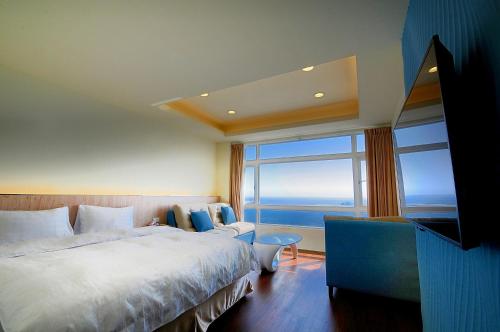 Katil atau katil-katil dalam bilik di 綠島 綠堤濱海旅店