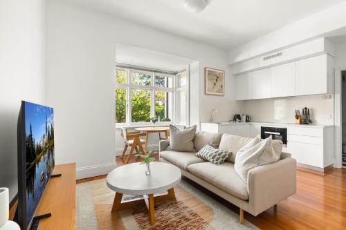 a living room with a couch and a table at Inner-West Studio in a Perfect Location in Sydney