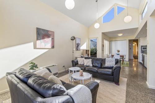 a living room with two couches and a table at Gorgeous 2-Bed Victorian Home in Artsy Suburb in Melbourne