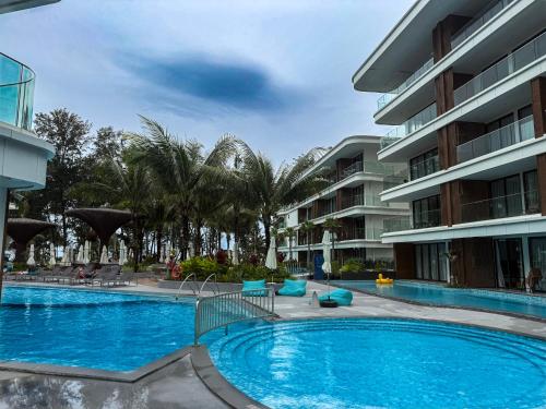 a large swimming pool next to a building at Sunshine Layan Beach Resort 2 bedroom #84192 in Layan Beach