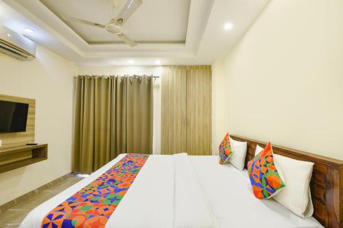 a bedroom with a large bed and a television at Hotel Supreme in Gurgaon